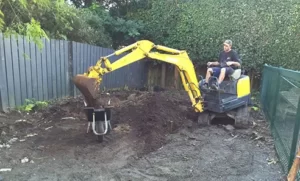 our expert builder on an excavator - new home builder auckland